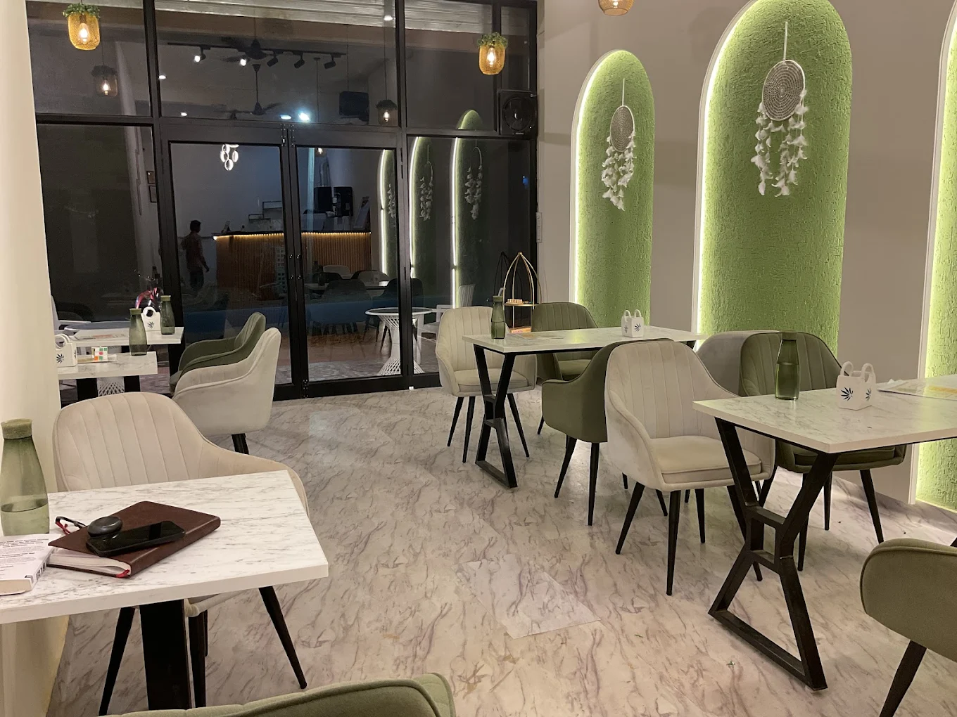 KAAFII Café Newai — beautiful green arch interior dining area at night